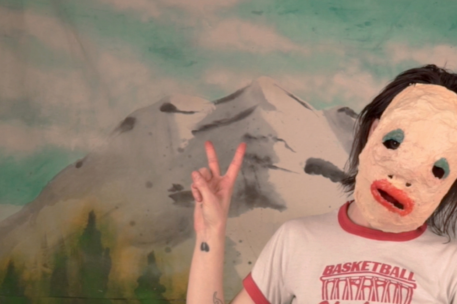 Du Blonde dons a papier-maché mask in the surreal, strangely celebratory video for 'Angel'